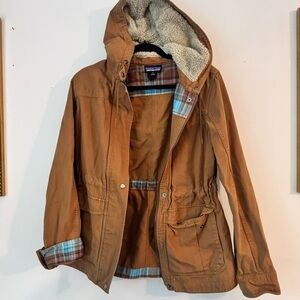 Patagonia size M canvas style jacket with pattern print and fuzzy hood.